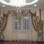 Sheer curtain complements the dramatic curtains with lambrequin