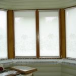White roller blinds on brown frames
