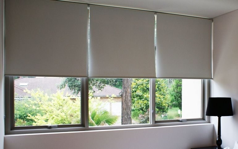 Large bedroom window with roller blinds