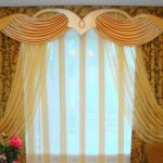 Yellow airy tulle and yellow-brown curtains with lambrequin