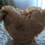 Beige pillow with roses and ruffles in the shape of a heart