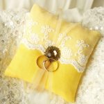 Colored cushion for wedding rings, reflecting the celebration palette