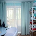 Turquoise curtains on the balcony window