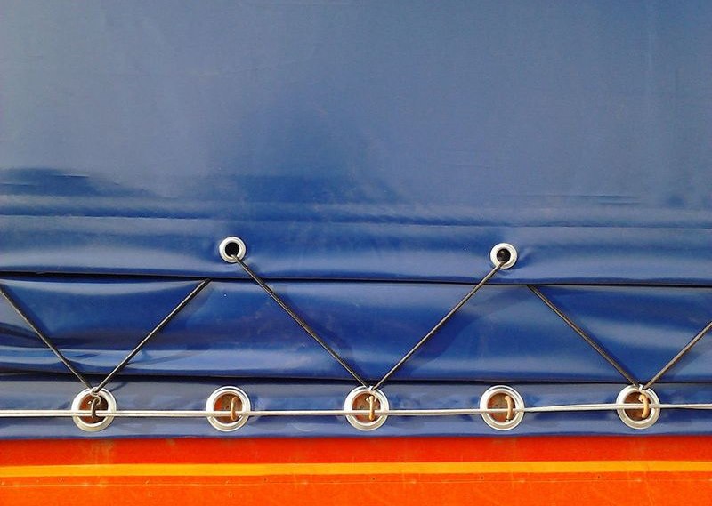 Cord fixing awning with grommets