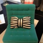 Small decorative pillow in the shape of a bow for a chair