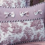 Gentle pillows with rustic patterns, bows and edging