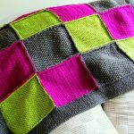 Plaid of bright knitted shreds squares