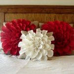 Pillows in the form of flowers on the bed