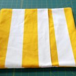 Striped wrap-around pillowcase on a square pillow