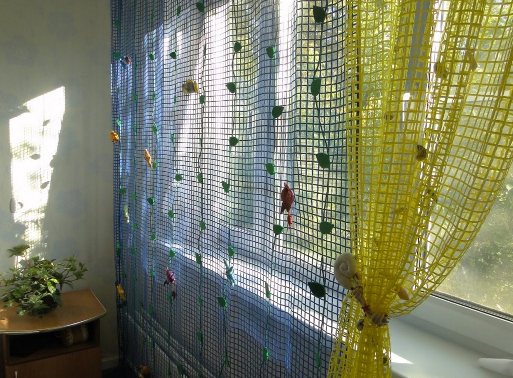 Multicolored tulle mesh on a plastic bedroom window