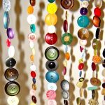 Curtain of colorful buttons with their own hands