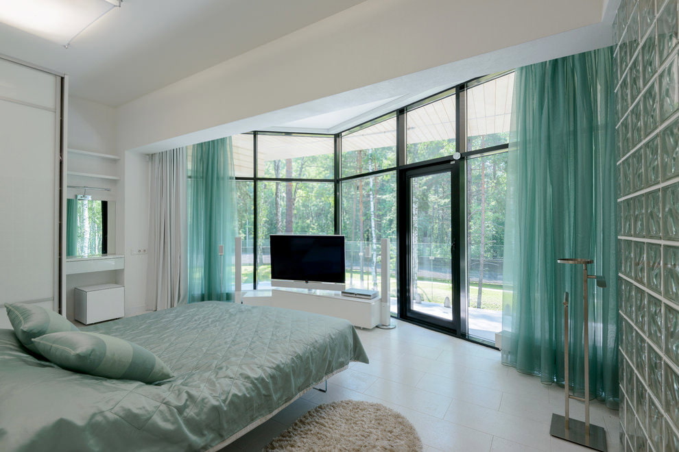 Large bedroom interior with turquoise curtains