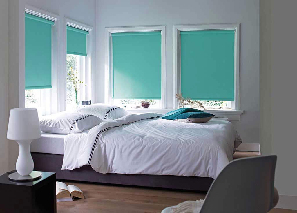 Turquoise roller blinds on the bedroom windows