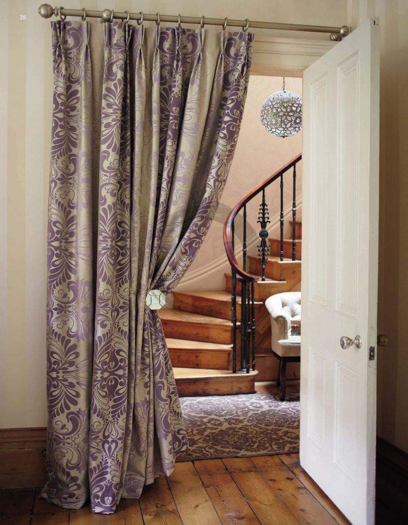 Beautiful curtain on the door to the hall with a staircase
