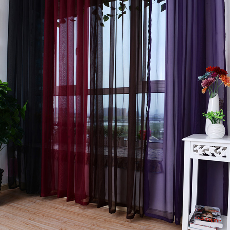 Wielokolorowy tiul w ciemnych kolorach na oknie w salonie