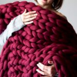 Warm blanket of natural wool in burgundy color