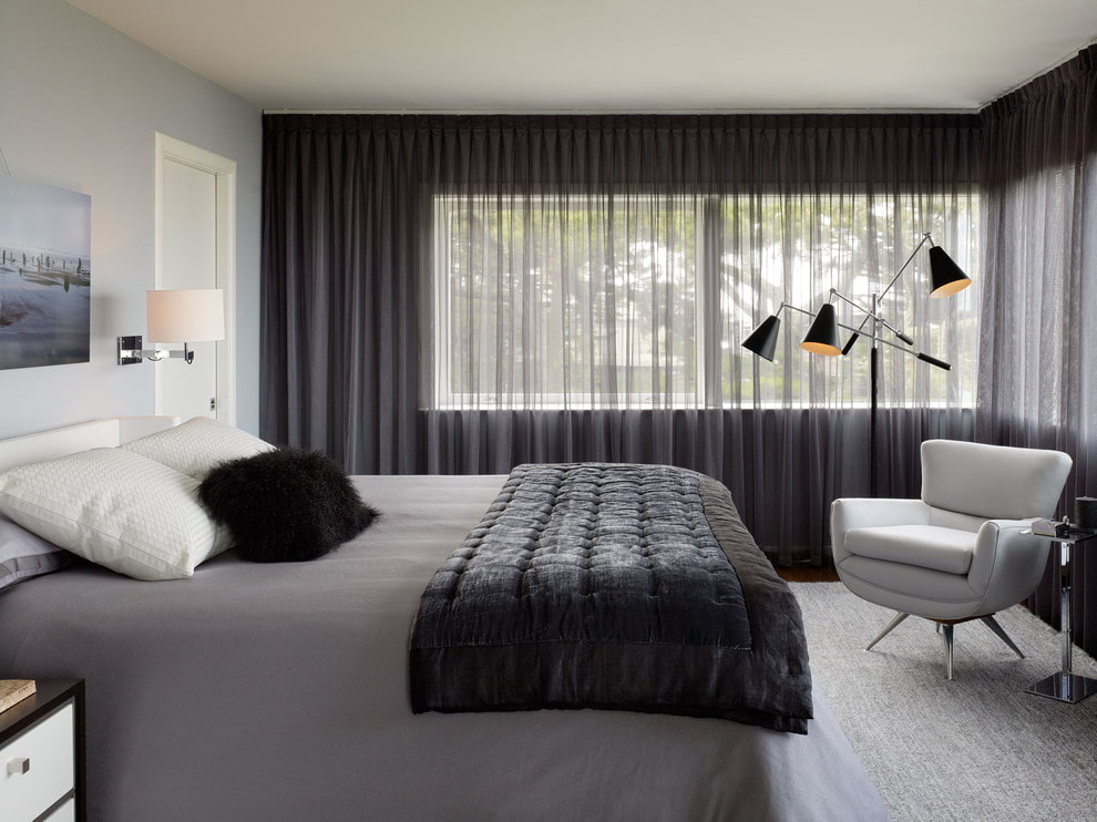 Gray tulle on the bedroom window with a window on the south side of the house