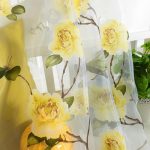 Gele bloemen op een doorschijnend gordijn