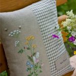 Outdoor cushion with embroidered field flowers