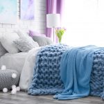 Knitted blue blanket can be used as a bedspread and blanket
