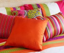 Bright decorative pillows in the bedroom interior