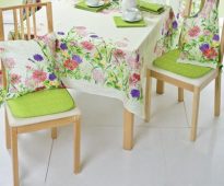 Bright green cushion seat and floral pillows under the back