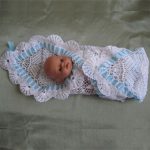 Openwork white blanket with a blue ribbon on the statement