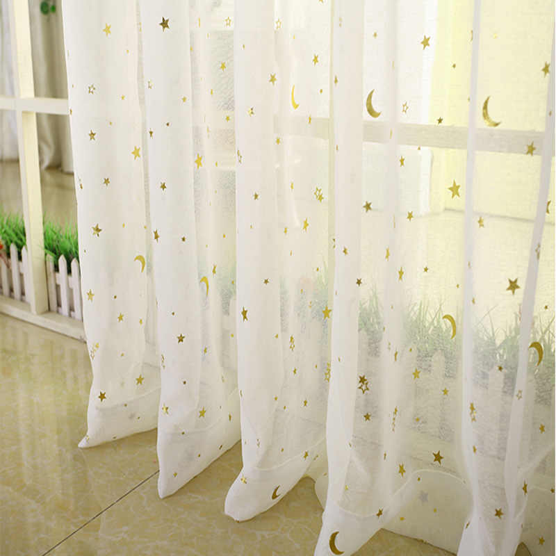 White tulle with stars on the window in the nursery