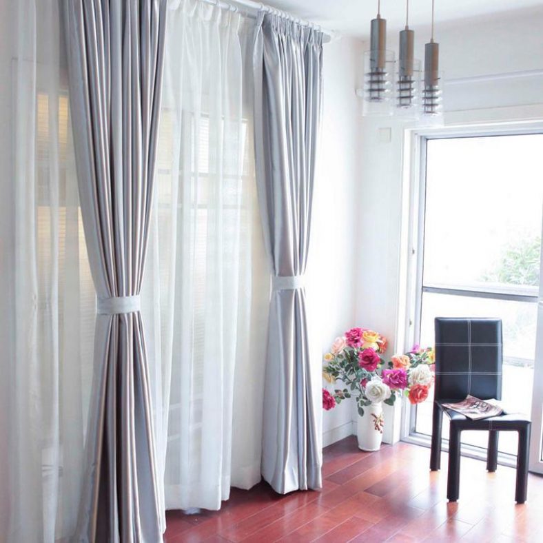 Beautiful curtains with grabs on the door in the living room