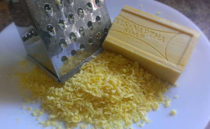Grinding a piece of soap on a grater for washing