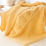 Volumetric yellow blanket with hearts pattern