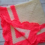 Milky-colored crochet plaid with coral decoration