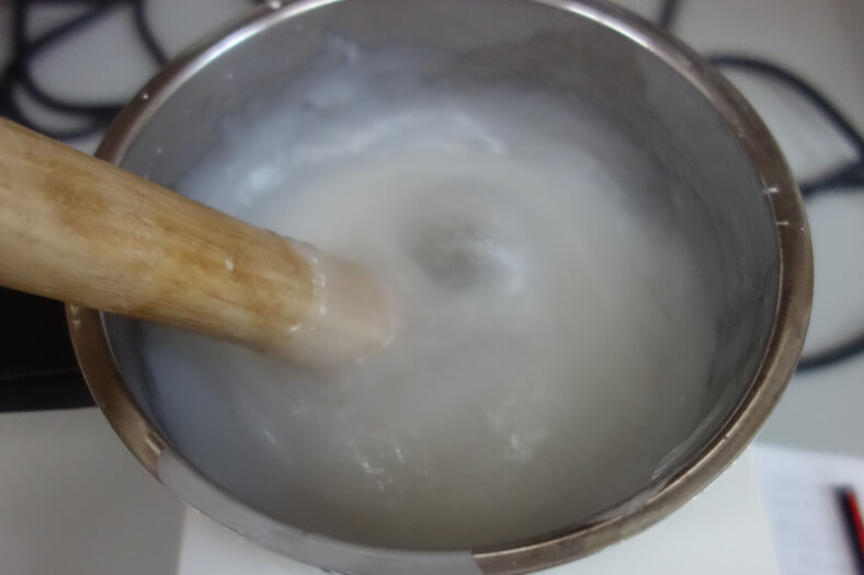 Dissolving starch in a container with warm water