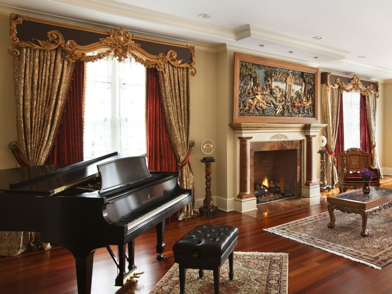 Curtains with a hard lambrequin in the living room with a grand piano