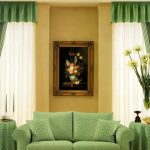 Symmetrical green curtains with a picture on the wall between them