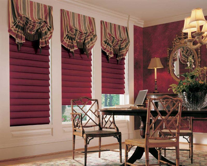 The combination of roman and french curtains on the windows of the cabinet