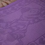 Knitted lilac blanket with animals and hearts