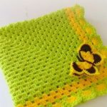 Knitted yellow-green plaid with a butterfly