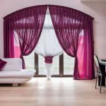 Purple curtains on a large window with an arch