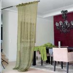 Hand-knitted long curtain in the living room