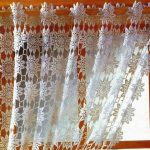 Knitted curtain of thin white thread