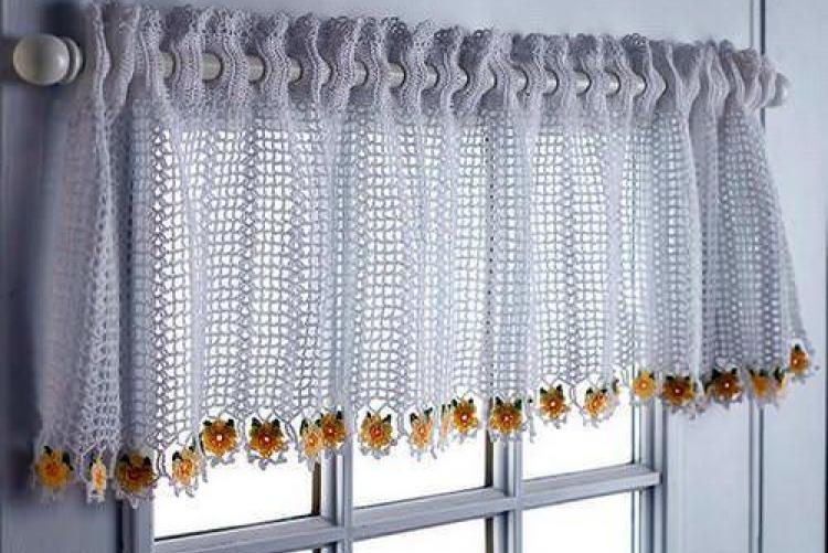 Hand-knitted short curtain on wooden window