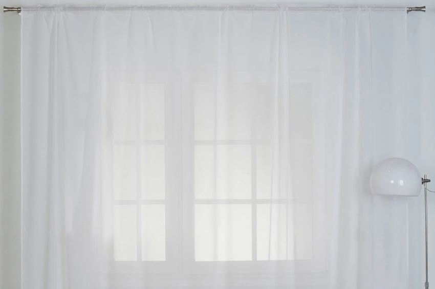 Thick tulle curtain on the living room window