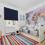Bright carpet with stripes on the floor in the nursery
