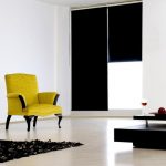 Yellow chair and black roll curtains