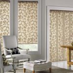 Beige curtains with ornaments on the windows of the living room