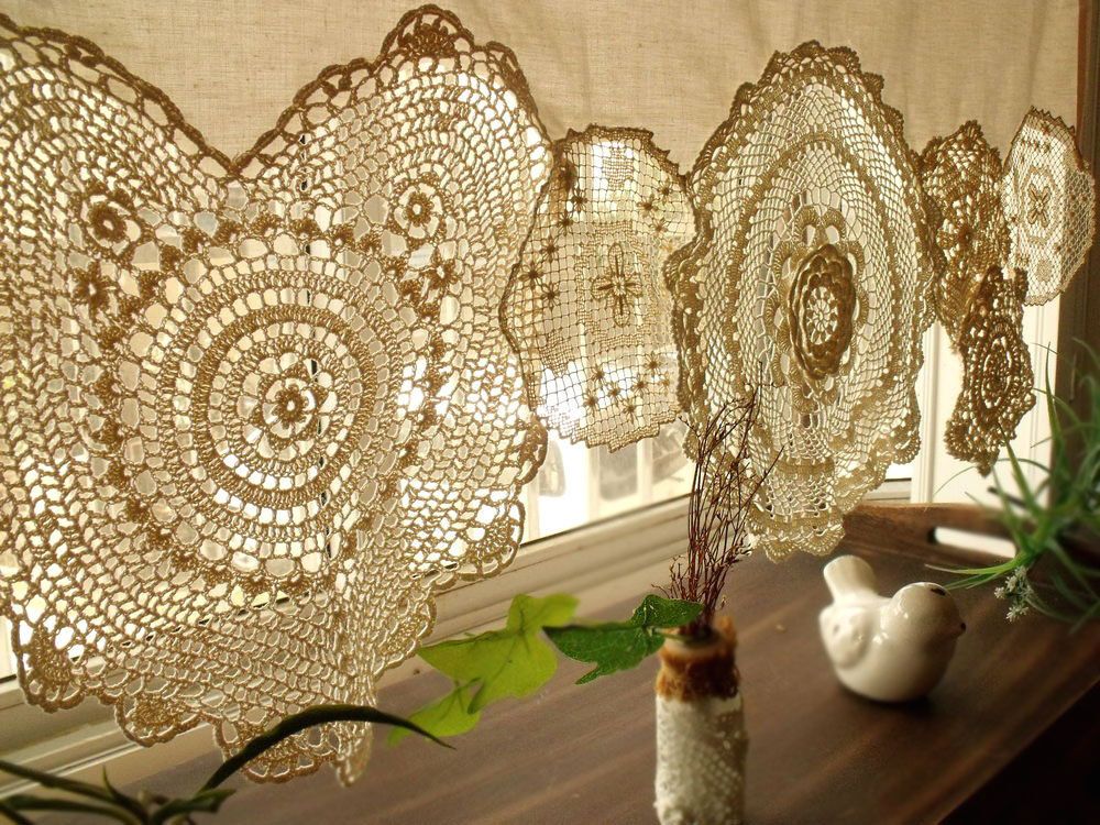 Beautiful knitted curtain on the window in a private house