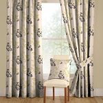 Curtains with petals and flowers and a pillow of the same fabric