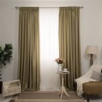 Straight curtains on the window of a room with plain walls.