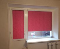 Dark pink roller blinds on the door and window
